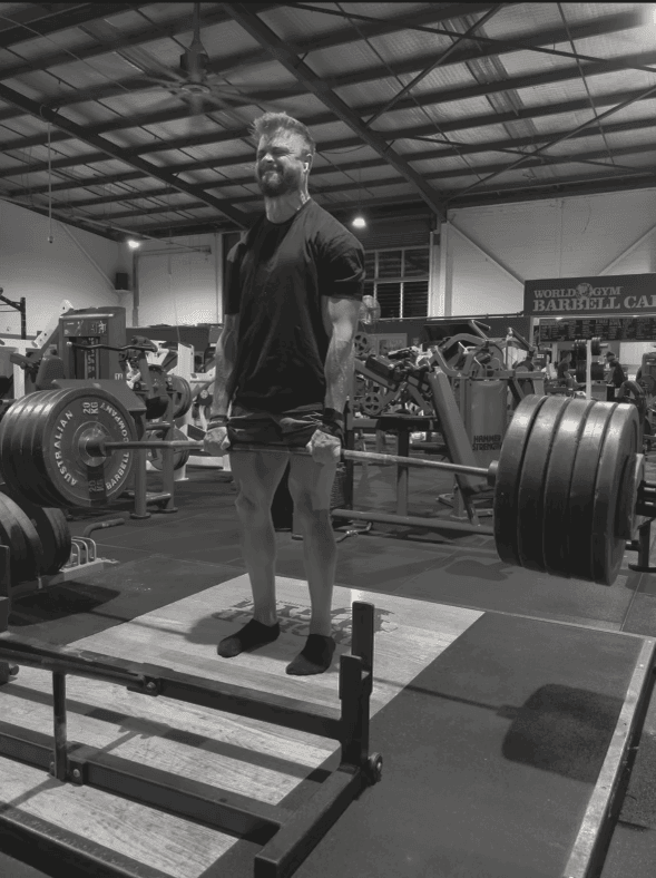 muscular man lifting weights in a gym